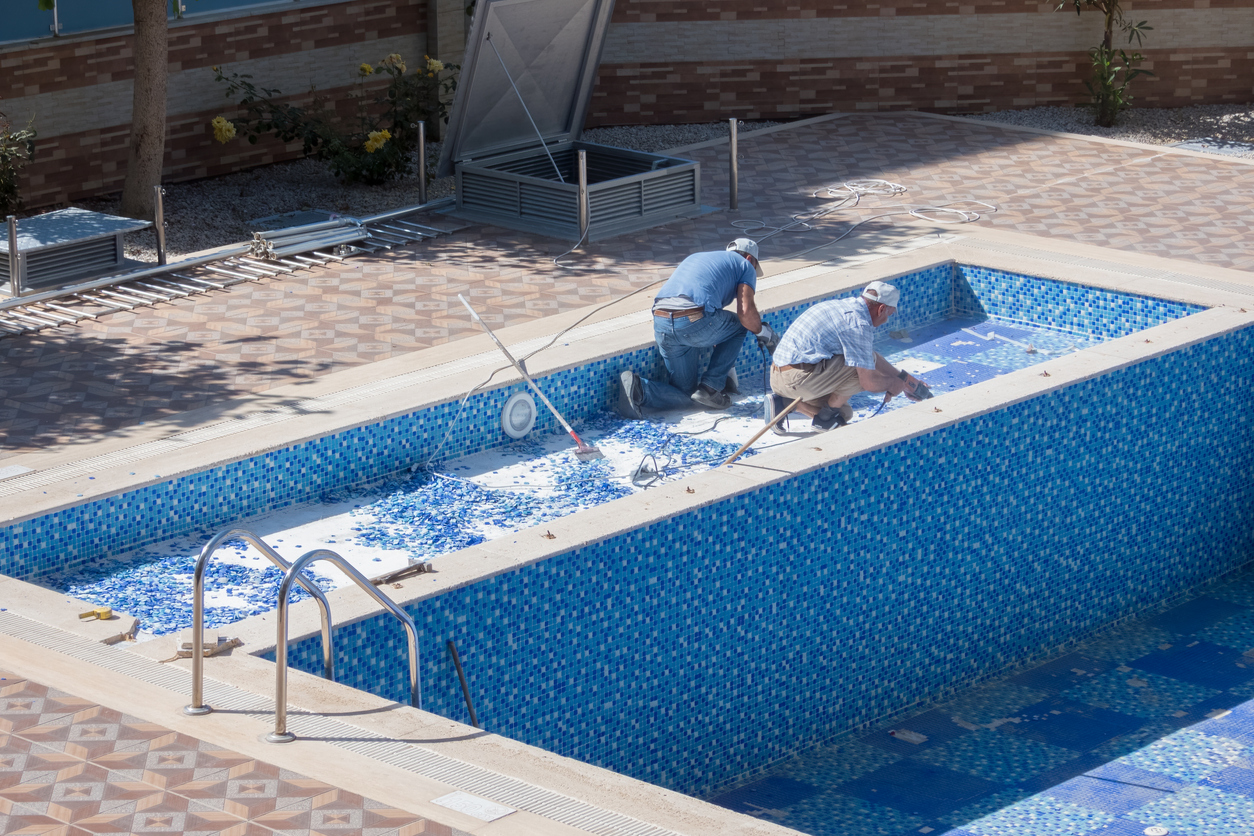 Two Professionals Maintaining A Pool