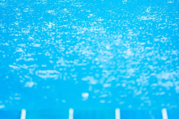 Raindrops in the blue swimming pool.